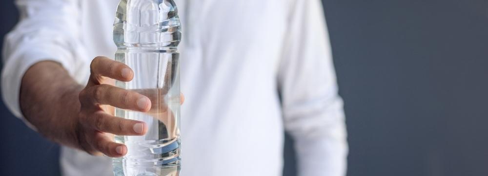 man holding glass of refreshing water