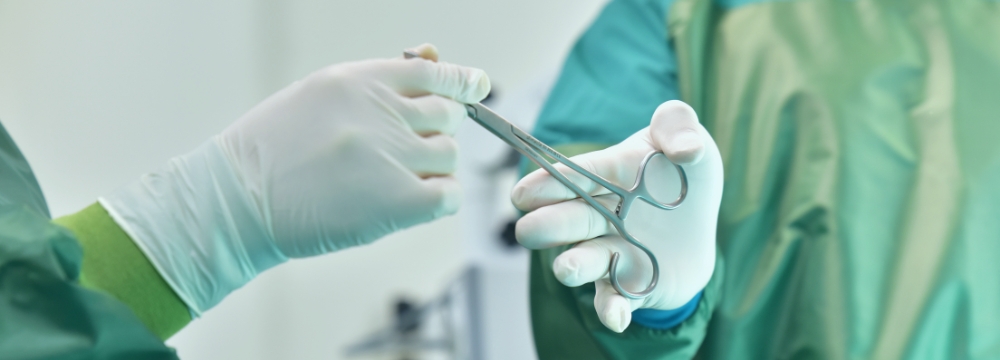 two surgeons passing off surgical instrument in the operating room during bariatric surgery