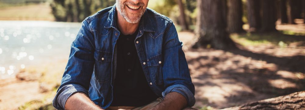 Man smiling in nature scene 